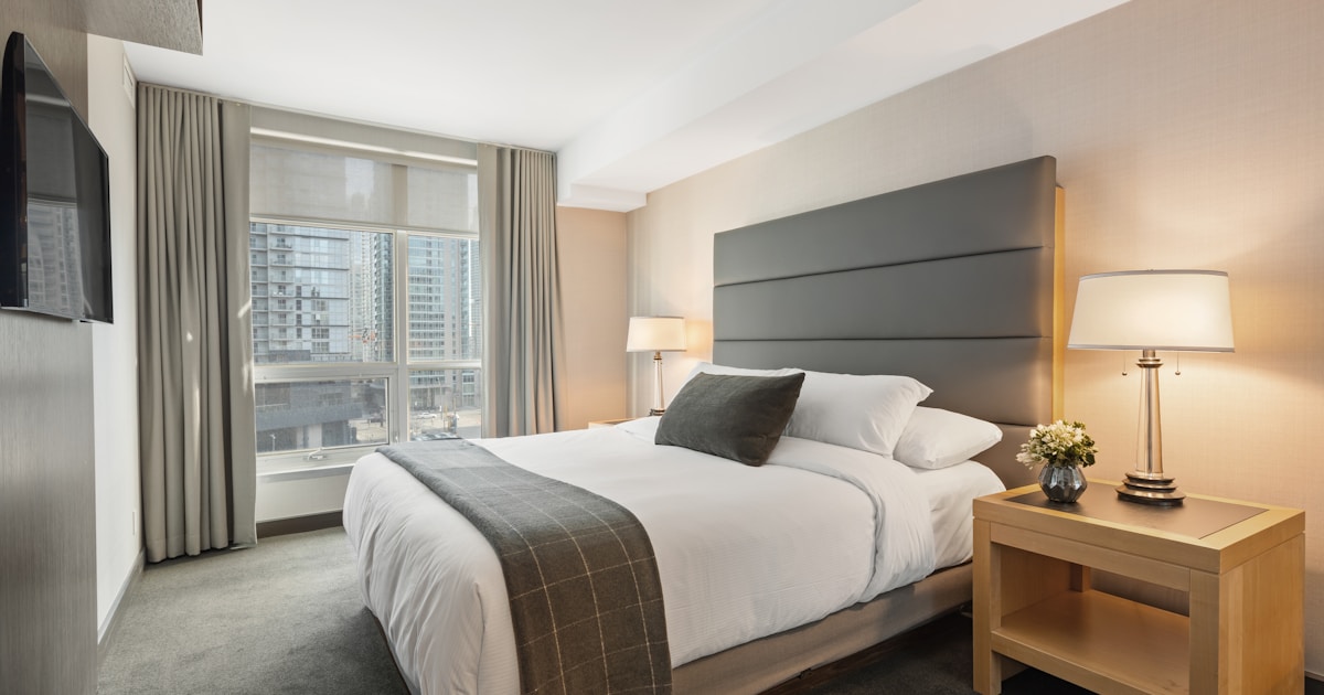 Crisp white bed sheets on a neatly made bed — cooling bamboo sheets for hot UK summer nights