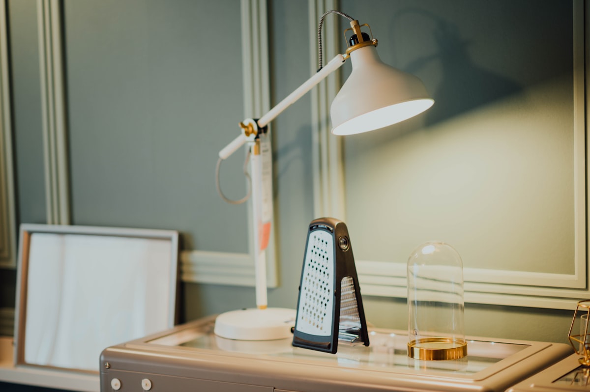 A bright light therapy lamp glowing on a desk - best SAD lamps UK 2026