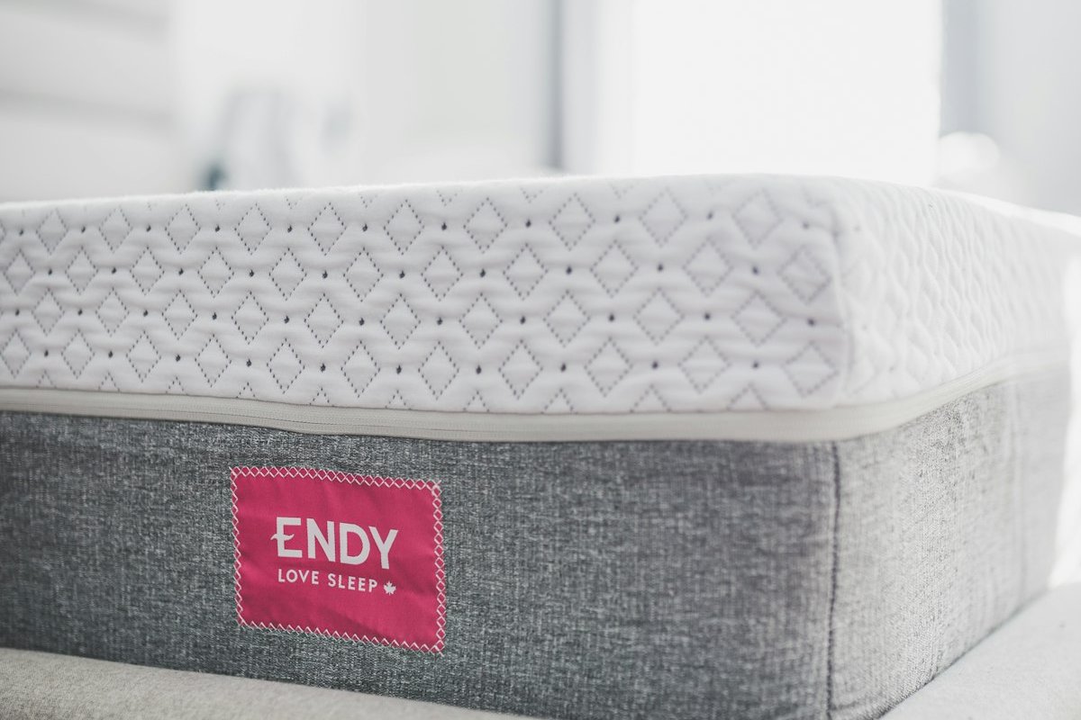 A firm mattress in a bright bedroom, the right support level for stomach sleepers