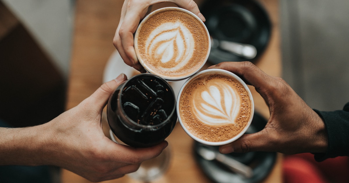 Caffeine and sleep — a cup of coffee beside a bed